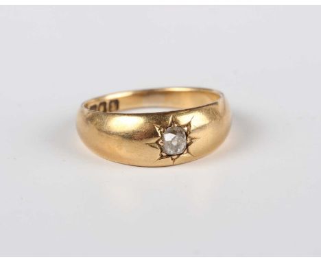 An 18ct gold and diamond single stone ring, star gypsy set with a cushion shaped diamond, London 1906, weight 5.6g, ring size