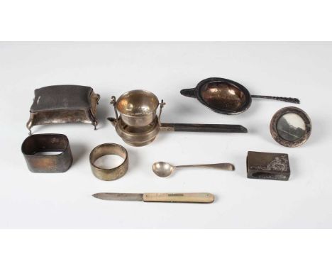 A George V silver tea strainer and stand of circular tapering form with pouring spout, fitted with an ebonized handle, Birmin