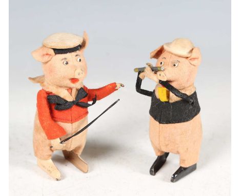 A Schuco felt clockwork pig playing a penny whistle and another playing a violin (lacking violin), height 11cm.