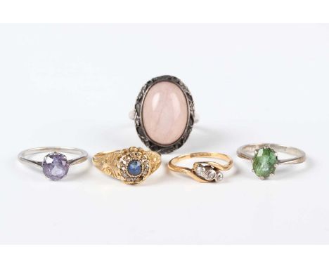 A gold and diamond three stone ring in a crossover design, mounted with cushion shaped diamonds, indistinct marks, weight 1.9
