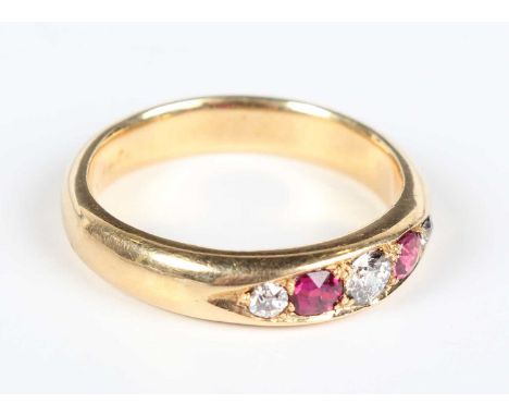 An 18ct gold, ruby and diamond five stone ring, mounted with two cushion shaped rubies alternating with three old cut diamond
