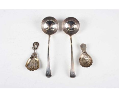 An early Victorian silver caddy spoon, the stylized leaf shaped bowl chased and embossed with a flowering stem, flanked by a 