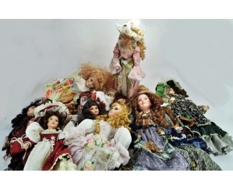 An impressive collection of larger ceramic / porcelain dolls, attractively presented by various makers. Some limited editions