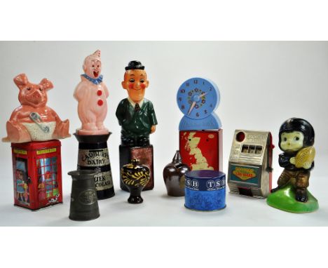 An eclectic group of vintage money box issues, inclusive of 1) Vintage Wetheriggs Penrith Pottery and Slipware Money Box orna