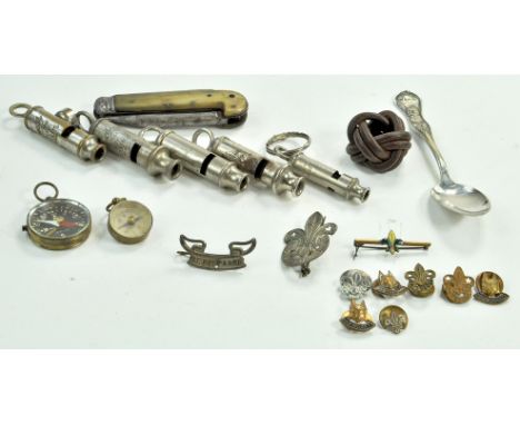 A very interesting collection of early 20th century Scout Whistles, badges, Compass and other related items. One such whistle