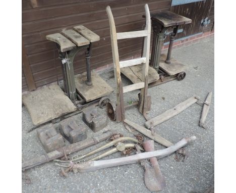 An early 20th century set of sack scales, 85cm tall, together with another similar, three weights, a sack barrow and a collec