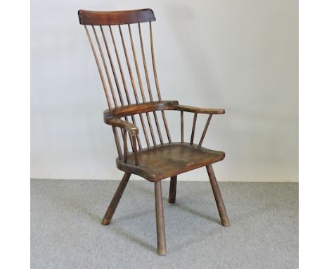 A 19th century elm seated stick back armchair 