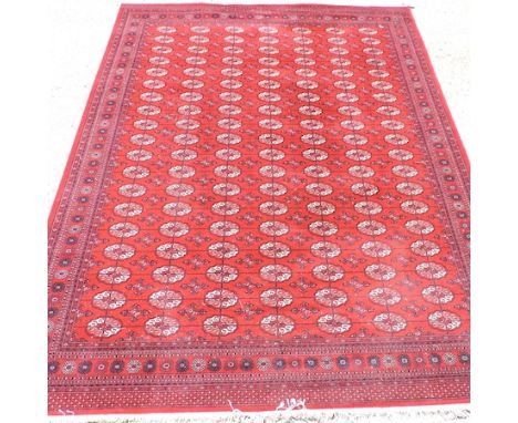 A modern Persian carpet, with all over designs on a red ground, 360 x 273cm
