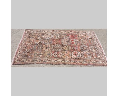 A Persian carpet, with all over designs within multiple borders on a cream ground, 285 x 165cm