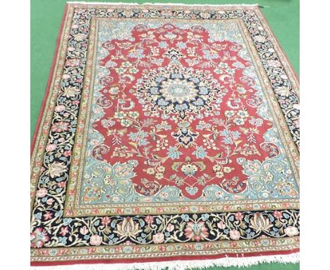 A Persian carpet, with floral designs on a red ground, 294 x 200cm