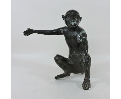 A bronze model of a monkey, 28cm tall