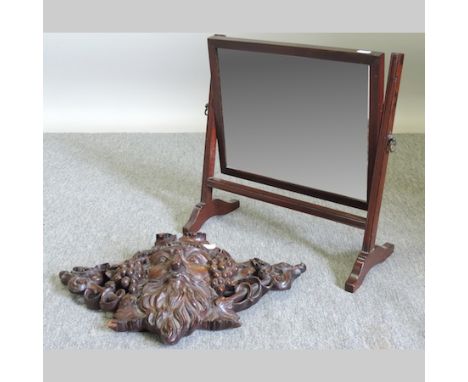 A 19th century carved green man wall bracket, 50cm, together with a 19th century swing framed toiletry mirror