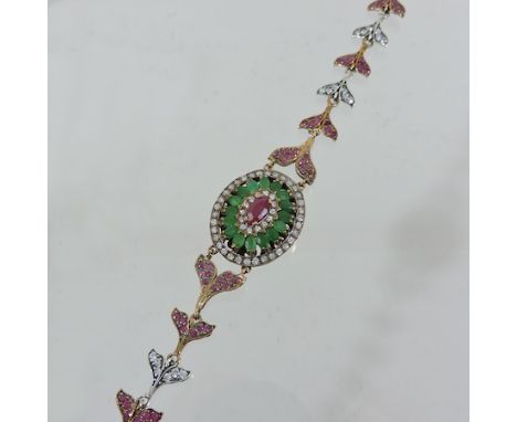 An early 20th century emerald, ruby and paste set bracelet