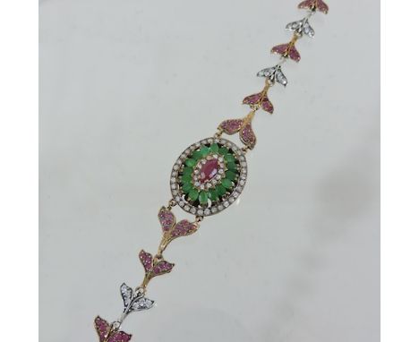 An early 20th century emerald, ruby and paste set bracelet