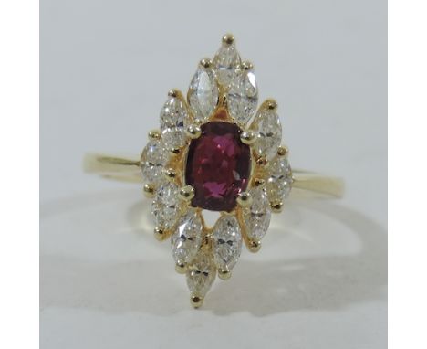 An 18 carat gold ruby and diamond cluster ring, boxed