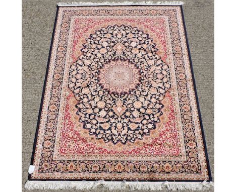 A Keshan carpet, with floral designs on a blue ground, 230 x 160cm