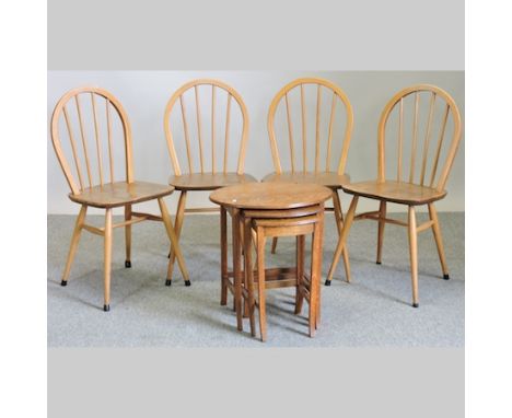 A set of four Ercol stick back dining chairs, together with a nest of three tables