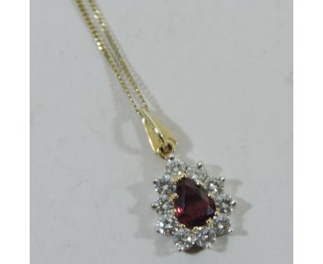 An 18 carat gold diamond and ruby pendant, on a 9 carat gold chain