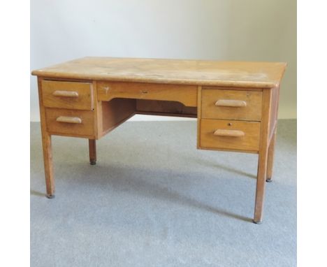 A 20th century light oak desk, 135cm