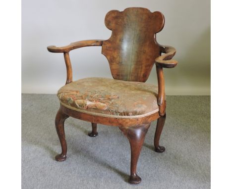 A 1920's walnut and tapestry upholstered armchair