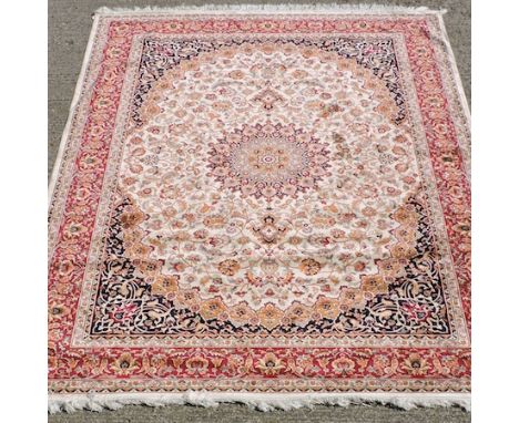 A Keshan carpet, with a central medallion and floral designs, on a cream ground, 280 x 200cm