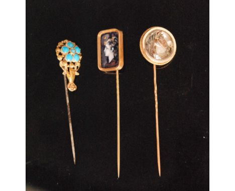 A 18ct Essex crystal horse head tie pin, together with two other stick pins, one with a rectangular blue enamel plaque depict