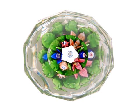 A 19th Century French paperweight by St Louis decorated with an upright bouquet having four lamp worked flowers with white ce