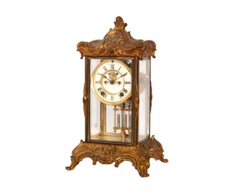 A 19th Century French brass mantle clock, the circular dial housed in four bevelled glass panelled sides above a twin mercury