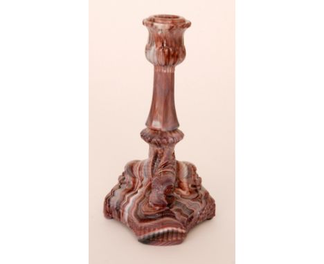 A late 19th Century purple malachite pressed glass candlestick formed as three dolphin heads forming the pedestal, unmarked b