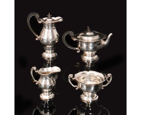 A George V Irish hallmarked silver four piece tea service comprising of tea pot, sugar bowl, cream jug and hot water pot, eac