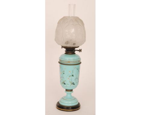 A Victorian over painted turquoise blue oil lamp and shade decorated with flowers and insects, together with chimney and etch