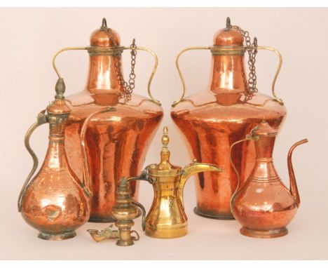 A pair of early 20th Century twin brass handled Eastern copper urns and covers of waisted form, height 55cm, together with tw