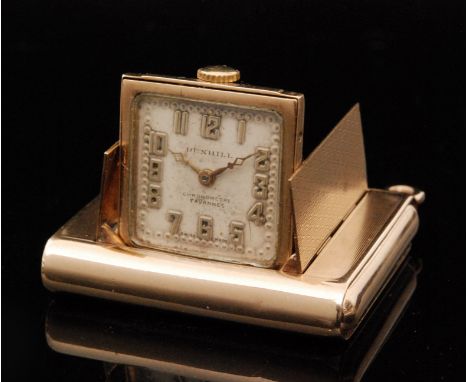 An Art Deco 9ct Dunhill purse watch contained within an engine turned case with push sides for shutter release and pendant lo