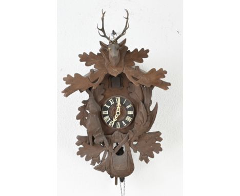 Old cuckoo clock. Germany. Circa 1930. With deer antlers. Light worm order. Dimensions: 60 cm. In decent shape.