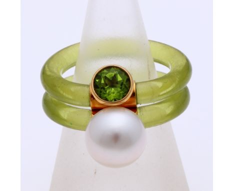 Design ring with a green plastic band, with a yellow gold element, 750/000, with a large pearl and green stone. ø 61. width 1