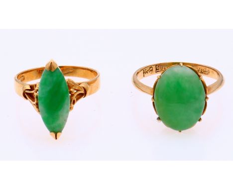 Two yellow gold rings, 585/000, with jade. A ring with an oval cabouchon cut jade, head width 15 mm. and a ring with a navett