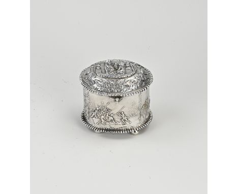 Silver tea caddy, 934/000, oval model decorated with warring figures with a scalloped edge. The hinged lid has a depiction wi