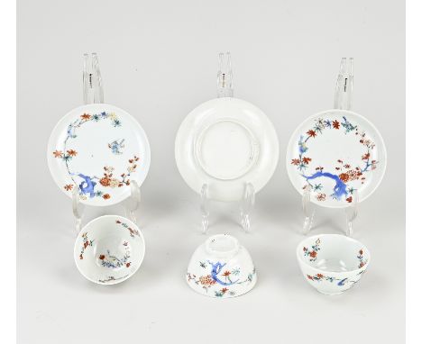 Three 18th century Japanese kakiemon cups + saucers with floral/bird decor. One cup of hairline + chip. One cup of baking err