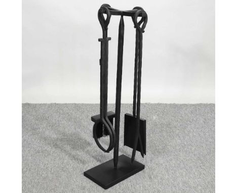 A modern wrought iron fireside companion set, on stand, 70cm high