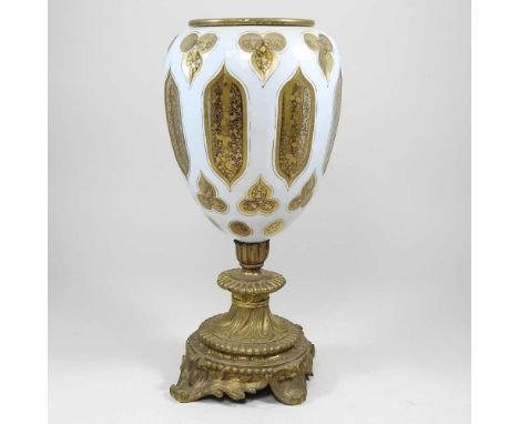 A gilt and overlaid glass oil lamp base, 32cm high