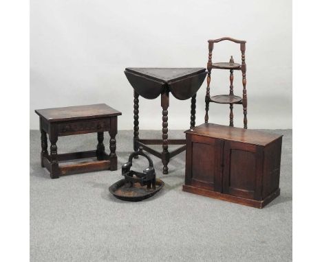 A small oak cabinet, together with a cake stand, stool, a cast iron boot scraper, a pair of iron fire dogs, and a drop leaf t