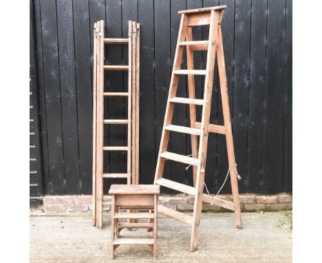 An extending wooden ladder, together with a wooden step ladder, 189cm high, and another smaller (3)All are used, dirty and wo