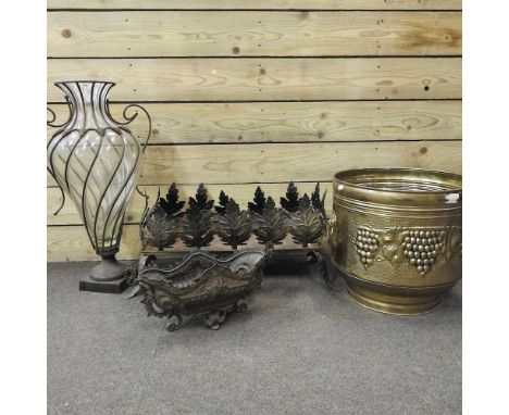 A floor standing glass vase, in a metal frame, 73cm high, together with two metal planters, a small stand and a brass jardini