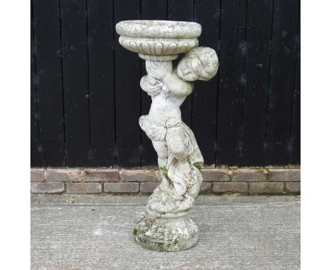 A cast stone planter in the form of a boy, 111cm high