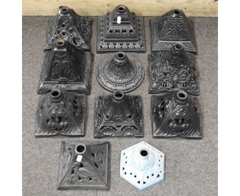 A collection of cast iron oil lamp bases, widest 17cm