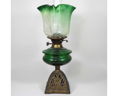 A cast iron oil lamp, with a green glass font and etched glass shade, 47cm high overallGenerally dirty, with light signs of w