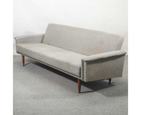 A 1950's grey upholstered sofa bed, on turned legs216w x 77d x 75h cm