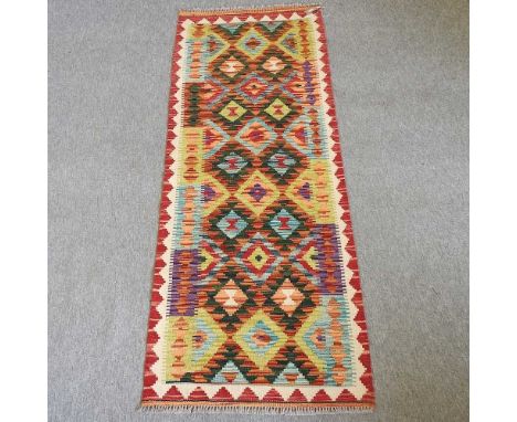 A kelim runner, with two rows of medallions and geometric design, 184 x 67cm