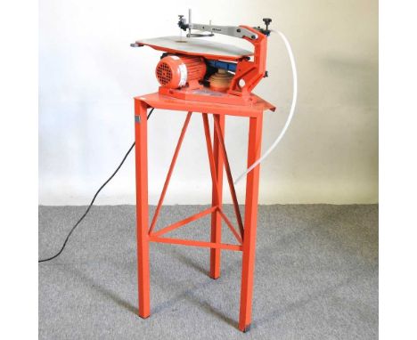 A Hegner electric fret saw, on stand, 110cm high