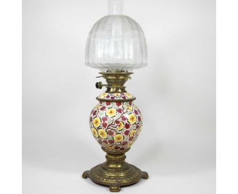 A brass and floral painted pottery oil lamp, with clear etched glass shade, 53cm high overallDirty with overall signs of ligh
